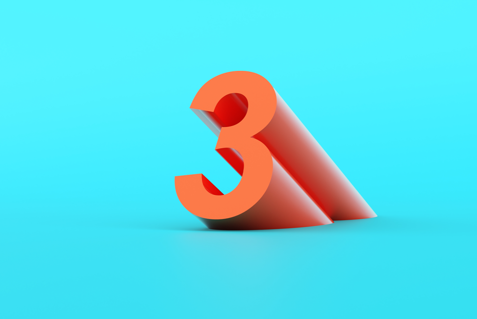 This image shows a projecting orange number three against a blue background.
