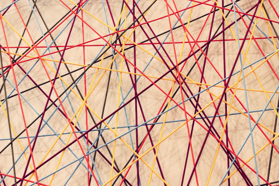 This image shows criss-crossing colorful lines against a light tan background.
